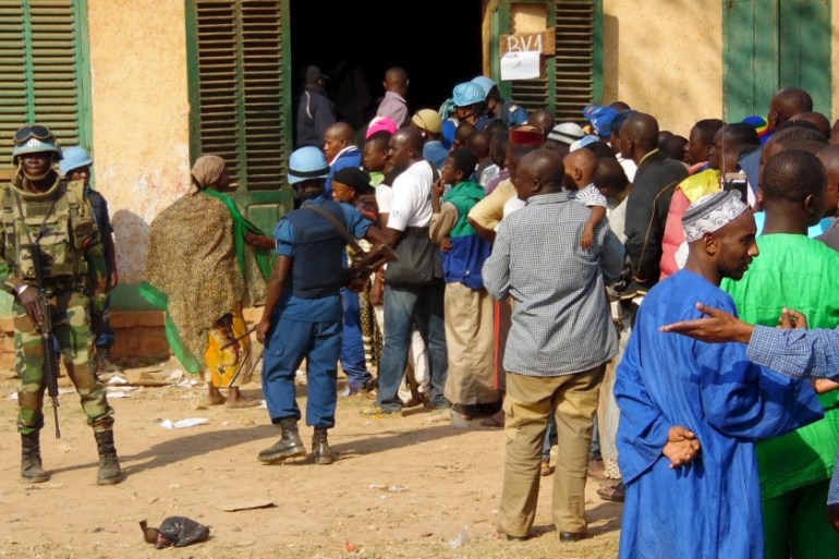 U.N. peacekeepers stand guard as the electorate queue to cast their ballots at a polling centre during the presidential election in the mainly Muslim PK-5 neighborhood in Bangui CAR