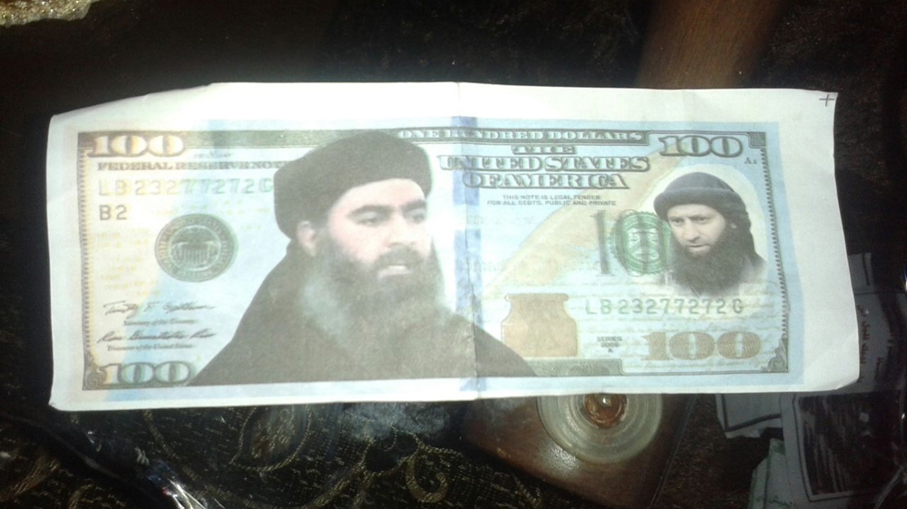 'American currency with ISIL leader Abu Bakr al-Baghdadi’s picture, indicating American/ISIL collusion' according to Layla Saleh [Salim al-Shami/Al Jazeera]