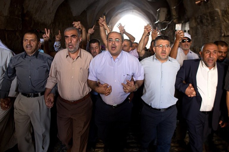 Arab Israeli Knesset member Ahmad Tibi takes part in a demonstration alongside a group of Palestinians in a street in the Muslim quarter of Jerusalem''s Old City [Getty]