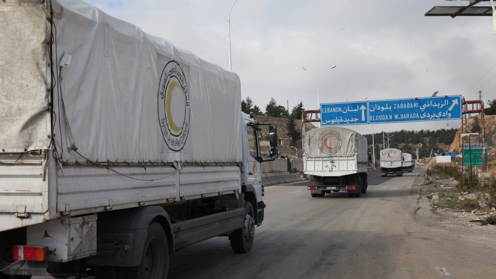 Trucks loaded with food, medicine, blankets and other materials head to the besieged town of Madaya on Thursday [Youssef Badawi/EPA] 