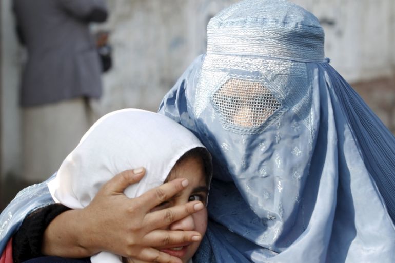 A woman holds her daughter''s head as they walk away after a blast near the Pakistani consulate in Jalalabad, Afghanistan [REUTERS]