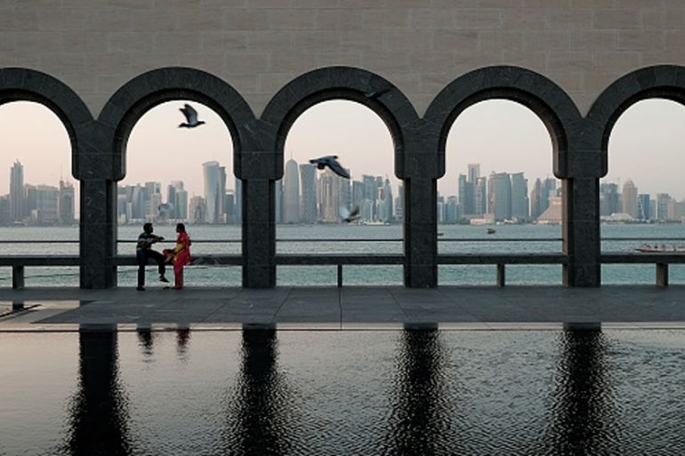 Visitors relax on the grounds the Museum of Islamic Art in Doha, Qatar [Getty]
