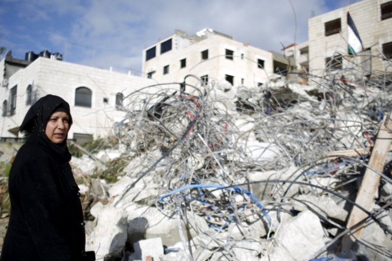 The mother of Palestinian Mohanad Al-Halabi stands next to her house after it was demolished by Israeli troops near Ramallah