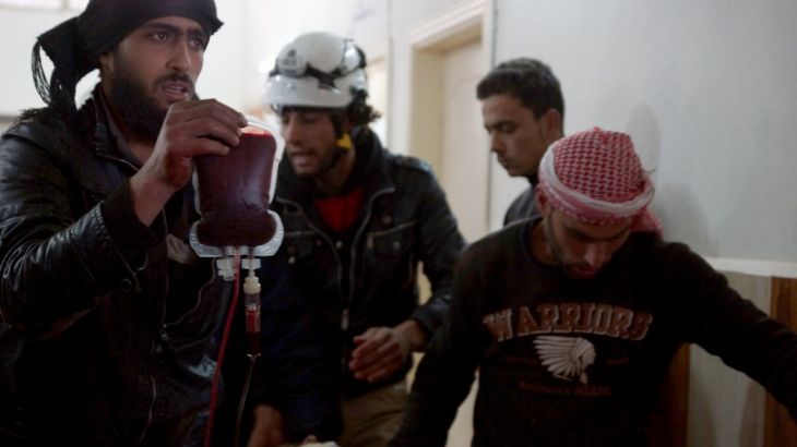 Men transport an injured man inside a field hospital after what activists said were airstrikes by forces loyal to Syria''s President Bashar al-Assad on the town of Abtaa