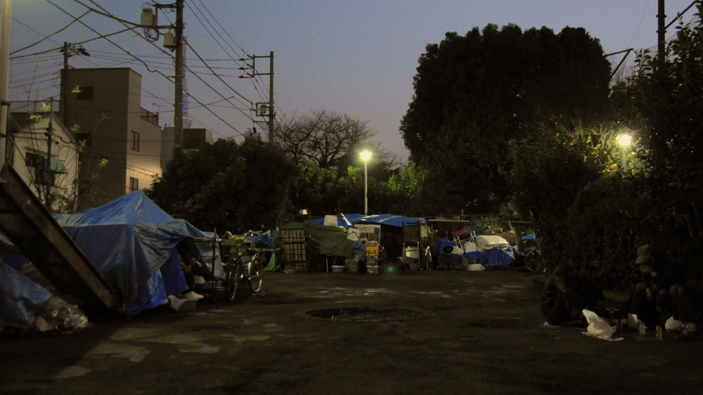 An encampment for the homeless in San'ya, Tokyo, historically a cheap lodgings area (doya-gai) also attracts destitute people [Joe Jackson/Al Jazeera]