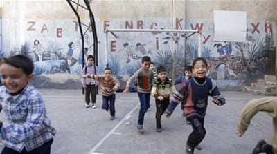 Pupils play in a school playground in Aleppo's Bustan al-Qasr [Reuters]