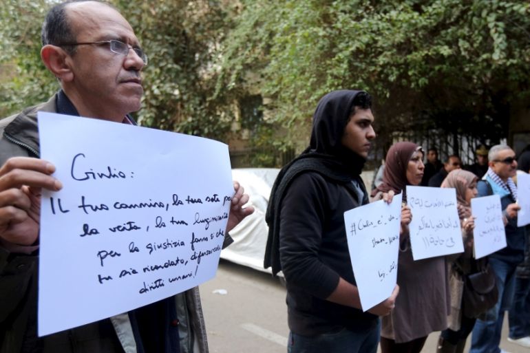 Activists hold placards during a memorial for Giulio Regeni outside of the Italian embassy in Cairo, Egypt