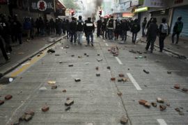 Bricks are seen behind riot police after a clash with protesters at Mongkok district in Hong Kong