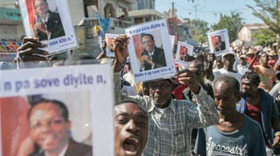 Opposition supporters protest against the current electoral decision making process at the parliament in Haiti [EPA]