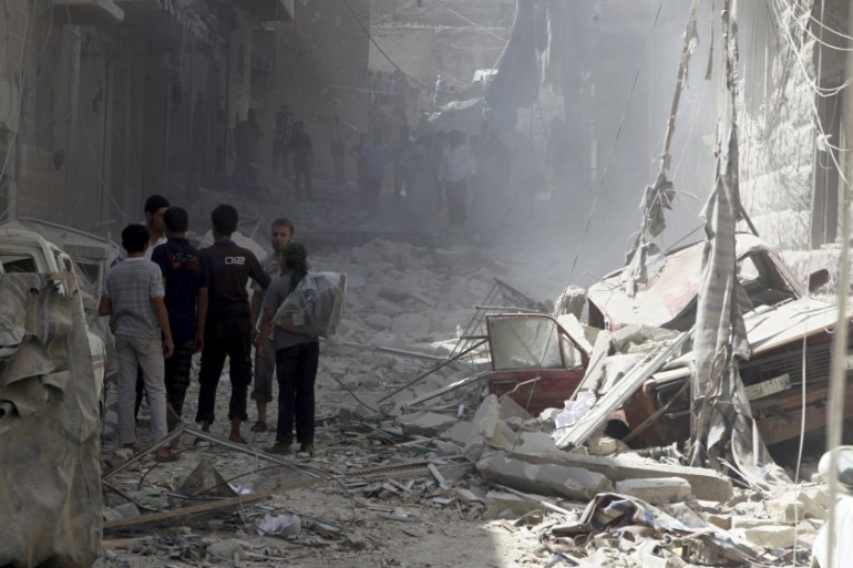 Residents inspect damage from what activists said was an airstrike by forces loyal to Syria''s President Bashar al-Assad in al-Ansari neighborhood of Aleppo, Syria