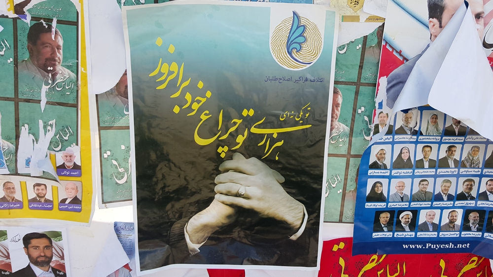 Publishing a photo of former president Mohammad Khatami in public has been banned, but posters with an image of his hands were all over the city during the campaign [Al Jazeera]