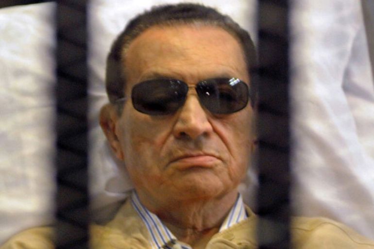 Ousted Egyptian president Hosni Mubarak sits inside a cage in a courtroom during his verdict hearing in Cairo on June 2, 2012 [AFP]