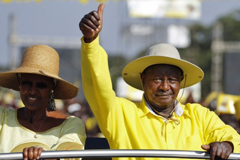 Accompanied by his wife Janet Museveni (L), Uganda''s incumbent President Yoweri Museveni (R) greets his supporters upon his arrival at his last campaign rally in Kampala, Uganda, 16 February 2016