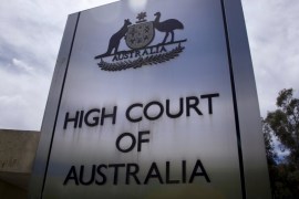 A sign stands outside the High Court of Australia in Canberra, Australia