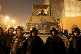 Riot police officers stand guard in front of the Cairo Security Directorate in Egypt