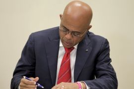 Haiti''s president Michel Martelly signs an agreement at the National Palace in Port-au-Prince, Haiti