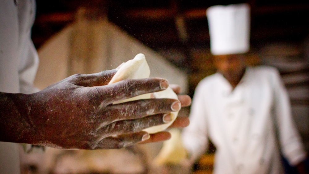 Kenyan bakers at Cedar's Lebanese restaurant in Nairobi spend their mornings baking thousands of pieces of pita bread.  [Jacob Kushner/Al Jazeera] 
