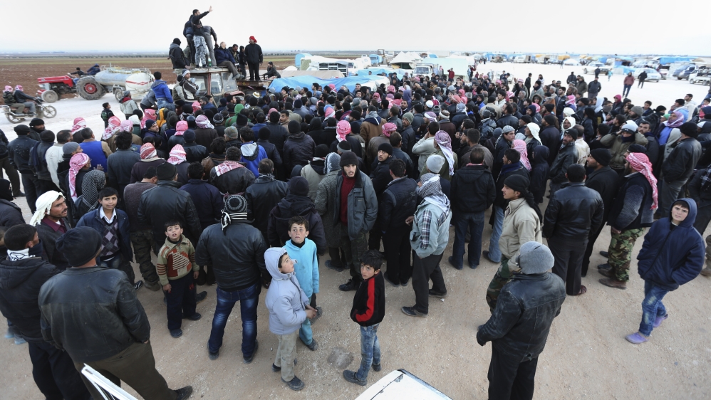 Syrians gather at the Bab al-Salameh border crossing with Turkey, in Syria on February 6, 2016 [AP]