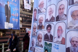 File photo of women walking past electoral posters for the upcoming elections in central Tehran
