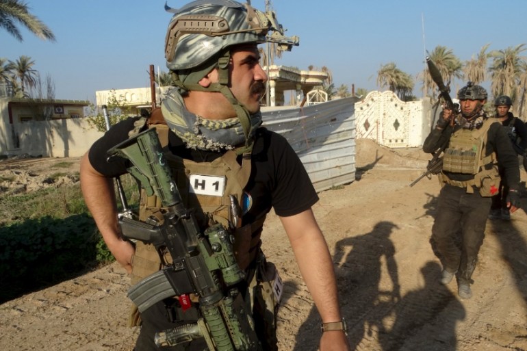 Iraqi security forces walk during patrol in the city of Ramadi