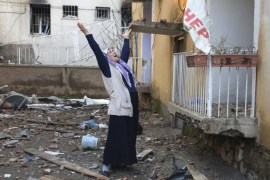 A woman cries in the compound of a destroyed police station in Cinar, Diyarbakir