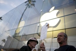 People gather at a small rally in support of Apple''s refusal to help the FBI access the cell phone of a gunman involved in the killings of 14 people in San Bernardino, in Santa Monica