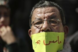 An Egyptian doctor covers his mouth with a paper reading, ''I feel bitter'', during a protest against rampant police abuses in Cairo, Egypt [AP]