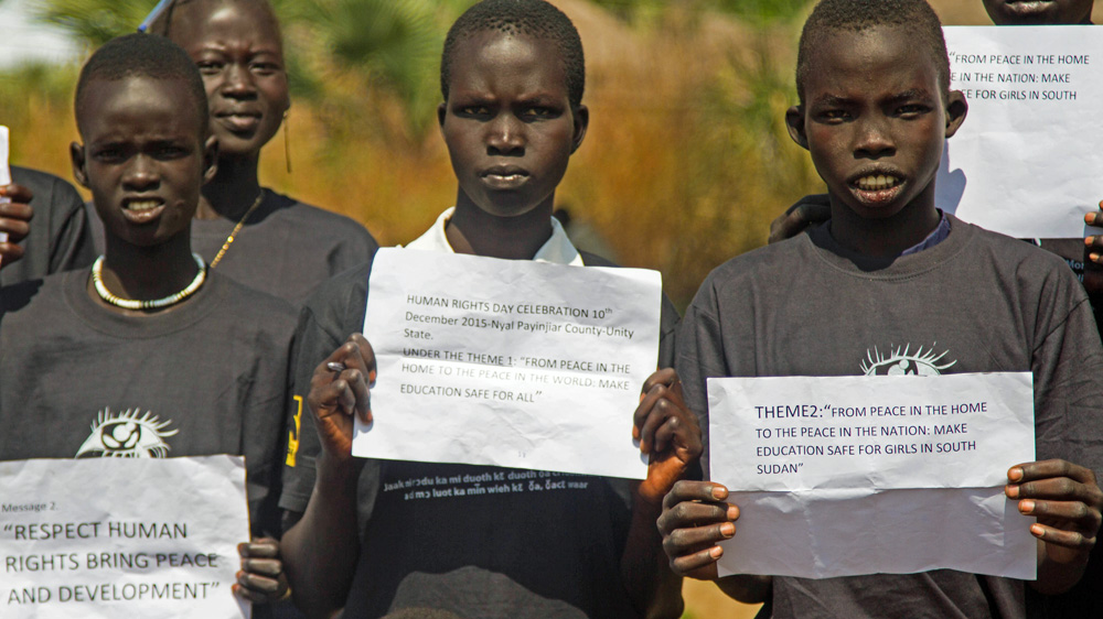 Schoolchildren joined an awareness campaign for women's rights organised by the International Rescue Committee in Nyal [Caitlin McGee/Al Jazeera]
