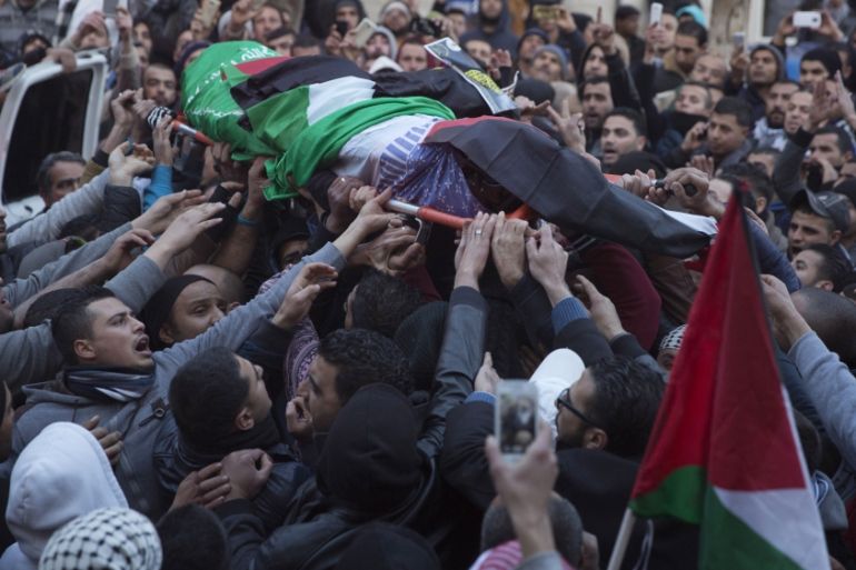 Palestinian mourners carry the body Hussein Abu Ghosh