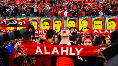 Al Ahly football club fans gather around photos depicting some of the victims killed in the Port Said match riots, on the fourth anniversary at the Al-Ahly football club in Cairo, Egypt [EPA]
