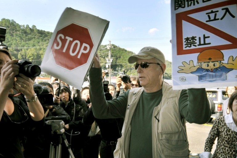 Ric O''Barry, a U.S. dolphin conservationist who appeared in the Oscar-winning documentary "The Cove", holds signs to protest against dolphin hunting in Taiji town