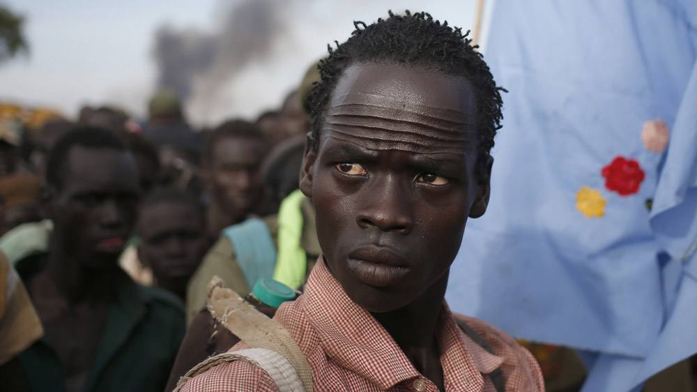 The Nuer facial markings make them easily identifiable. Jikany Nuer White Army fighters walk in rebel-controlled territory in Upper Nile State [Goran Tomasevic/Reuters]