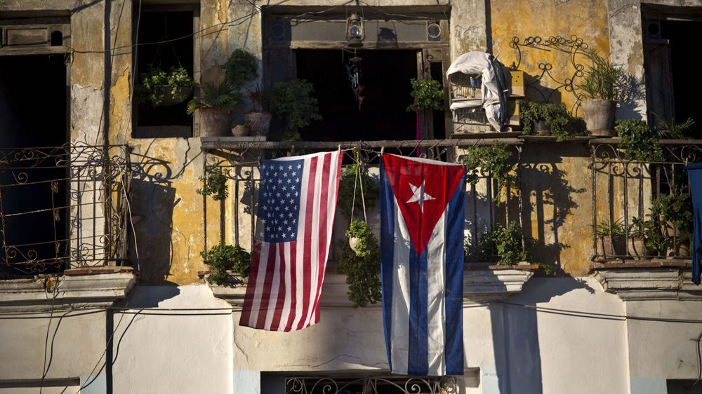 A US and Cuban flag hang from the same balcony in Old Havana, Cuba [AP Photo/Ramon Espinosa]