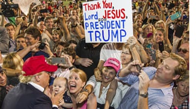Trump supporters hold placard thanking Jesus [Getty]