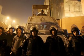 Riot police officers stand guard in front of the Cairo Security Directorate [REUTERS]