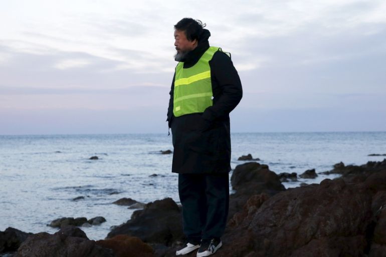 Chinese artist Ai Weiwei stands at a beach where refugees and migrants arrive daily on the Greek island of Lesbos [REUTERS]