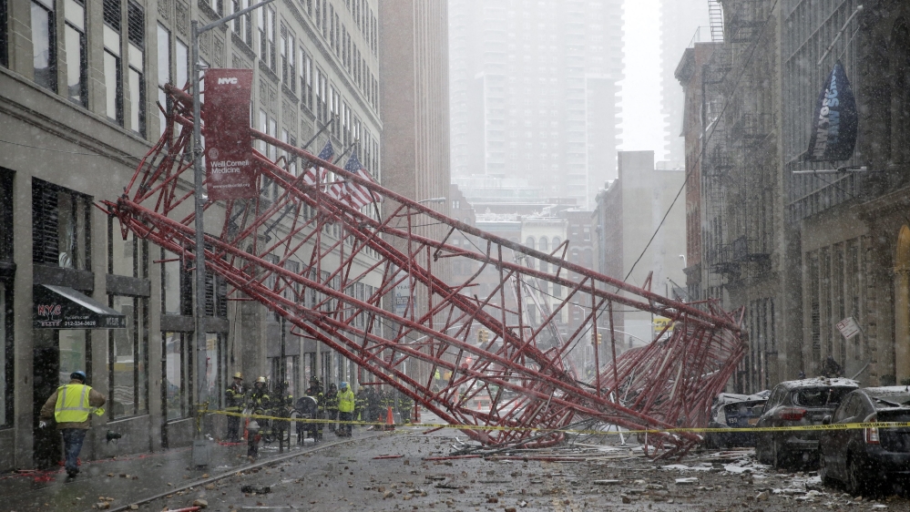 Firemen survey the damage of a fallen crane in Worth Street, Lower Manhattan, New York City [Jason Szenes/EPA]
