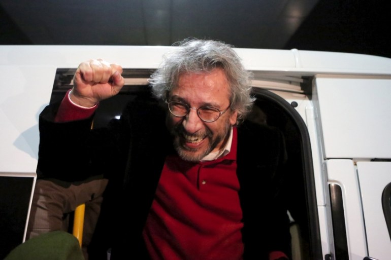 Editor-in-chief of Cumhuriyet Can Dundar reacts after being released from prison outside the Silivri prison complex near Istanbul