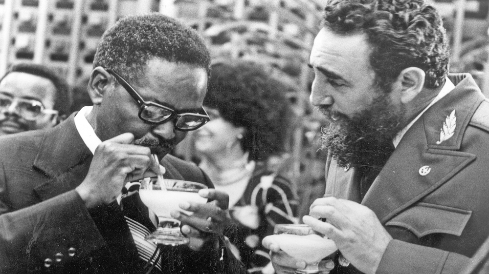 Castro, right, showing Angolan leader Agostinho Neto how to drink a daiquiri [AP]