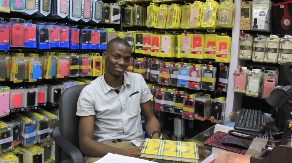 Musa Kateregga, 25, IT graduate and mobile phone storekeeper in Kampala, Uganda [Trinna Leong/Al Jazeera]