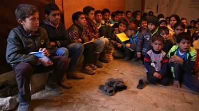 Syrian refugee children sit on the ground as they listen to their teacher inside a tent that has been turned into a makeshift school at a Syrian refugee camp in Qabb Ilyas, a village in the Bekaa Valley, Lebanon [AP]