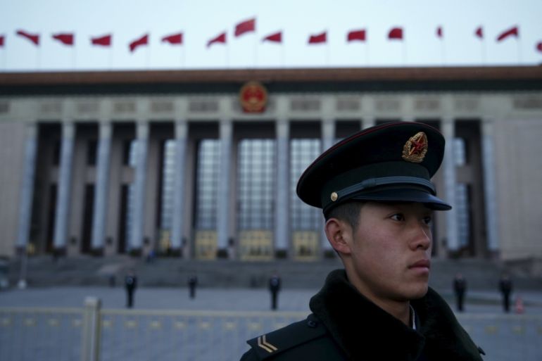 A soldier of the People''s Liberation Army stands guard in front of the Great Hall of the People ahead of the opening session of the National People''s Congress in Beijing, China