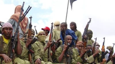 Al-Shabab fighters sit on a truck as they patrol in Mogadishu [AP]