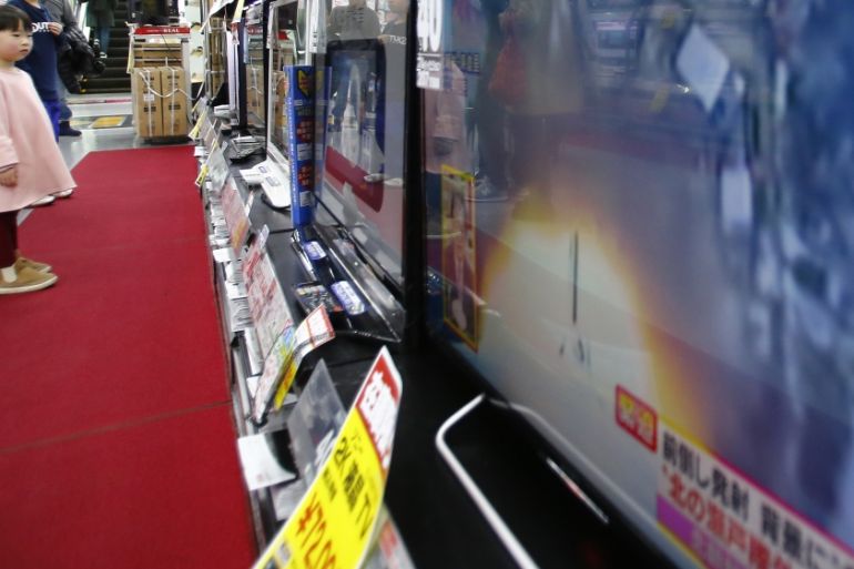 Children watch TV screens reporting North Korea''s rocket launch at an electronics store in Tokyo