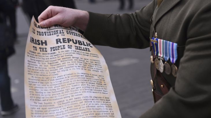 A member of the Irish Armed Forces displays a copy of the Irish Proclamation before the commemoration of the 100 year anniversary of the Irish Easter Rising in Dublin