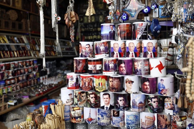 Local Syrian shop sell mugs with photos of Bashar al-Assad, Vladmir Putin, Hezbollah leader Hassan Nassrallah, and the national Syrian flag in the old city of Damascus, Syria [EPA]