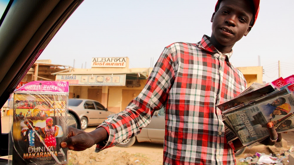 Kannywood movies are big sellers in Kano traffic [Femke van Zeijl/Al Jazeera]