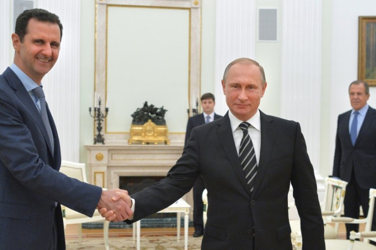 Russian President Vladimir Putin shakes hands with Syrian President Bashar Assad in 2015 [AP]