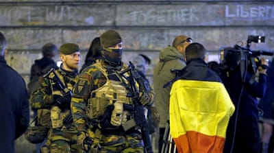 Belgian soldiers patrol as people pay tribute to the victims of bomb attacks [Reuters]