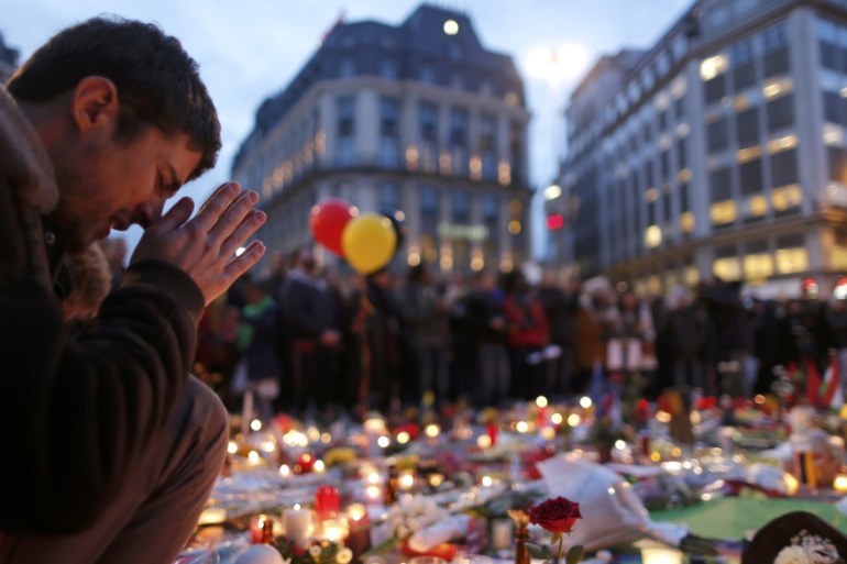 A man attends a memorial gathering near the old stock exchange in Brussels following bomb attacks in Brussels, Belgium